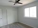 This is a bright bedroom with a ceiling fan, a window, and a closet at 7753 W Plymouth S Pl, Littleton, CO 80128