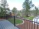 Outdoor deck offering a view of the landscaped backyard and storage shed at 7753 W Plymouth S Pl, Littleton, CO 80128