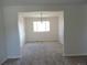 Bright dining room boasts fresh paint, new carpet, and lots of natural light from large window at 7753 W Plymouth S Pl, Littleton, CO 80128