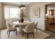 Inviting dining room with a modern table, stylish chairs, and soft natural light at 7753 W Plymouth S Pl, Littleton, CO 80128