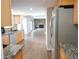 View from kitchen to the great room featuring granite counters and stainless appliances at 7753 W Plymouth S Pl, Littleton, CO 80128