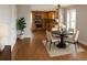 Modern kitchen with wooden cabinets, stainless steel appliances, and an adjacent dining area at 7753 W Plymouth S Pl, Littleton, CO 80128