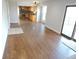 Spacious living area with hardwood floors connecting to the kitchen and leading to an outdoor deck at 7753 W Plymouth S Pl, Littleton, CO 80128