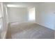Open living room with neutral carpet, large windows, and neutral paint at 7753 W Plymouth S Pl, Littleton, CO 80128