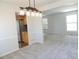 Open-concept living space with kitchen access, new carpet, and lots of natural light at 7753 W Plymouth S Pl, Littleton, CO 80128