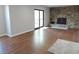 Bright living room featuring a stone fireplace, hardwood floors, and patio access at 7753 W Plymouth S Pl, Littleton, CO 80128