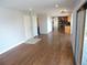 Bright living room features hardwood floors and neutral paint, flowing into kitchen at 7753 W Plymouth S Pl, Littleton, CO 80128