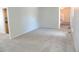 Neutral carpeted living room with stairs to the second level at 7753 W Plymouth S Pl, Littleton, CO 80128
