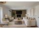Bright living room featuring a stone fireplace, modern furniture, and contemporary art at 7753 W Plymouth S Pl, Littleton, CO 80128