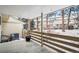 Covered back patio with view of fenced backyard and neighboring townhomes at 6885 E Briarwood Cir, Centennial, CO 80112