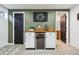 Finished basement bar area with sleek mini-fridge and modern wooden countertop at 6885 E Briarwood Cir, Centennial, CO 80112
