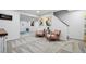 Basement layout with seating, art and workout space with neutral carpeting at 6885 E Briarwood Cir, Centennial, CO 80112