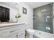 Modern bathroom features gray tiled shower with recessed shelves, and white vanity at 6885 E Briarwood Cir, Centennial, CO 80112