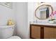 Stylish half bath featuring modern vanity, marble countertop, and charming decor at 6885 E Briarwood Cir, Centennial, CO 80112