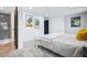 Bright bedroom features neutral tones, recessed lighting, and an en-suite bathroom with tiled shower at 6885 E Briarwood Cir, Centennial, CO 80112
