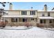 Townhome rear exterior featuring a covered patio and a gated yard space with sparse landscaping at 6885 E Briarwood Cir, Centennial, CO 80112