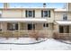 Backyard exterior with covered patio and a gated yard space with sparse landscaping at 6885 E Briarwood Cir, Centennial, CO 80112