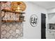 Eye-catching kitchen with modern backsplash and décor, featuring a sign, shelves, and a pendant light at 6885 E Briarwood Cir, Centennial, CO 80112