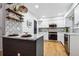 Modern kitchen featuring white cabinets, stainless steel appliances, and a stunning tile backsplash at 6885 E Briarwood Cir, Centennial, CO 80112