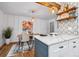Open-concept kitchen with marble counters, pendant lighting, and an adjacent dining area at 6885 E Briarwood Cir, Centennial, CO 80112