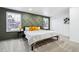 Serene bedroom featuring modern accent wall, comfortable bed, and ample natural light at 6885 E Briarwood Cir, Centennial, CO 80112