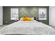 Well-lit bedroom featuring accent wall, comfortable bed, and scenic outdoor views at 6885 E Briarwood Cir, Centennial, CO 80112