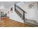 Contemporary staircase with sleek black railing and plush carpeting at 6885 E Briarwood Cir, Centennial, CO 80112