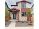 Inviting two-story home with stone accents, covered porch, and a blue front door at 21104 E 63Rd Dr, Aurora, CO 80019