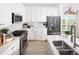 Modern kitchen with stainless steel appliances, white countertops and ample cabinet space at 21104 E 63Rd Dr, Aurora, CO 80019