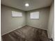 Neutral bedroom with two windows providing natural light and plush carpet at 3038 S Xenia Ct, Denver, CO 80231