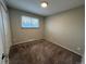 Bedroom with cozy carpet, neutral walls, and a bright window at 3038 S Xenia Ct, Denver, CO 80231
