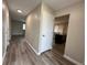 Inviting hallway with hardwood floors and modern neutral-colored walls at 3038 S Xenia Ct, Denver, CO 80231