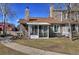 Beautiful backyard featuring mature trees, manicured lawn, a patio with a table and chairs at 8450 Everett Way # D, Arvada, CO 80005