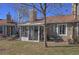 Beautiful backyard featuring mature trees, manicured lawn, a patio with a table and chairs at 8450 Everett Way # D, Arvada, CO 80005