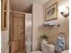 This bathroom offers a glass shower with a pebble tile floor, modern fixtures, and warm neutral paint at 8450 Everett Way # D, Arvada, CO 80005