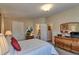 Bright bedroom featuring neutral walls, bedside tables and lamps, and an en-suite bathroom for added privacy at 8450 Everett Way # D, Arvada, CO 80005