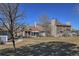 Charming multi-story townhomes with stone chimneys and well-maintained landscaping at 8450 Everett Way # D, Arvada, CO 80005