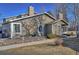 Charming home featuring a stone chimney, well-kept landscaping, and walkway leading to the entrance at 8450 Everett Way # D, Arvada, CO 80005