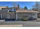 Exterior view of home showing an attached 2-car garage, neutral siding, and mature landscaping at 8450 Everett Way # D, Arvada, CO 80005