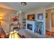 Cozy living room featuring a fireplace, TV, neutral walls, an area rug, and large picture windows at 8450 Everett Way # D, Arvada, CO 80005