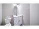 A modern half bathroom with a white vanity, sink, and toilet at 46561 Avery Ln, Bennett, CO 80102