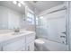 Clean bathroom with a white vanity, a toilet and a bathtub with glass shower doors at 46561 Avery Ln, Bennett, CO 80102