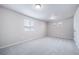 Spacious bedroom with neutral walls and carpeting, brightened by a window with blinds at 46561 Avery Ln, Bennett, CO 80102