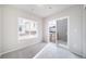 Bedroom featuring light gray carpet, a window with blinds, and sliding glass door at 46561 Avery Ln, Bennett, CO 80102