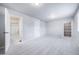 Bright bedroom with carpet, featuring access to a bathroom and a walk-in closet at 46561 Avery Ln, Bennett, CO 80102
