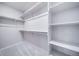 Walk-in closet with ample shelving and hanging space, offering plenty of storage at 46561 Avery Ln, Bennett, CO 80102