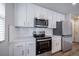 The kitchen has stainless steel appliances, white cabinets, and a subway tile backsplash at 46561 Avery Ln, Bennett, CO 80102