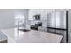 This kitchen features stainless steel appliances, white cabinets, and a large island with a quartz countertop at 46561 Avery Ln, Bennett, CO 80102