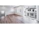 Modern living area with wood floors, neutral walls, and sliding glass doors offering a glimpse of the exterior at 46561 Avery Ln, Bennett, CO 80102