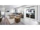 Sun-filled living room boasts a comfortable sectional sofa and sliding glass doors at 46561 Avery Ln, Bennett, CO 80102